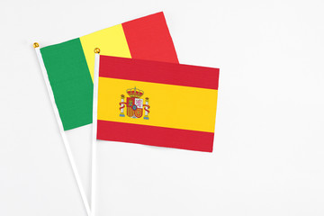 Spain and Senegal stick flags on white background. High quality fabric, miniature national flag. Peaceful global concept.White floor for copy space.