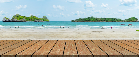 long wooden table with beach landscape blur background