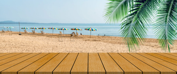 long wooden table with beach landscape blur background