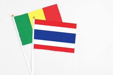 Thailand and Senegal stick flags on white background. High quality fabric, miniature national flag. Peaceful global concept.White floor for copy space.