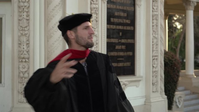 man delivers speach doctorates graduatIon 