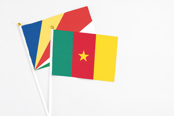 Cameroon and Seychelles stick flags on white background. High quality fabric, miniature national flag. Peaceful global concept.White floor for copy space.v