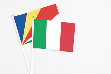 Italy and Seychelles stick flags on white background. High quality fabric, miniature national flag. Peaceful global concept.White floor for copy space.v