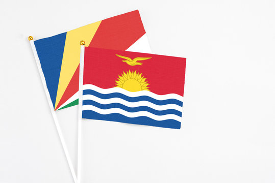 Kiribati and Seychelles stick flags on white background. High quality fabric, miniature national flag. Peaceful global concept.White floor for copy space.v
