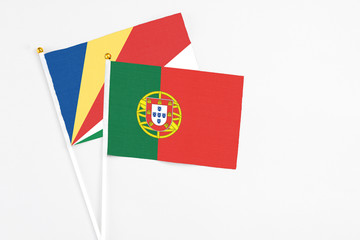 Portugal and Seychelles stick flags on white background. High quality fabric, miniature national flag. Peaceful global concept.White floor for copy space.v