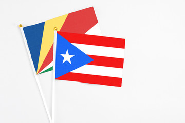 Puerto Rico and Seychelles stick flags on white background. High quality fabric, miniature national flag. Peaceful global concept.White floor for copy space.v
