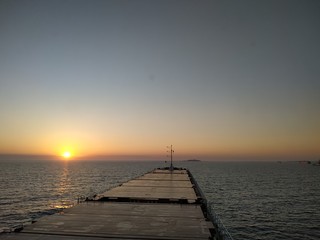 Fototapeta na wymiar old wooden pier at sunset