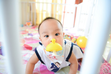 Cute Asian little baby boy chewing teething