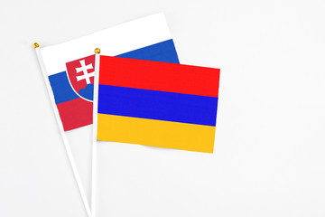 Armenia and Slovakia stick flags on white background. High quality fabric, miniature national flag. Peaceful global concept.White floor for copy space.