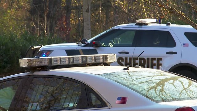 SHERIFF CARS PARKED WITH LIGHTS ON