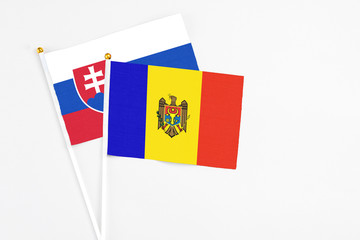 Moldova and Slovakia stick flags on white background. High quality fabric, miniature national flag. Peaceful global concept.White floor for copy space.