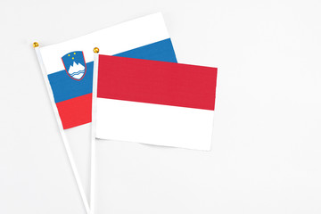 Indonesia and Slovenia stick flags on white background. High quality fabric, miniature national flag. Peaceful global concept.White floor for copy space.