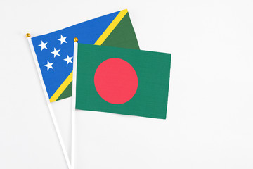 Bangladesh and Solomon Islands stick flags on white background. High quality fabric, miniature...