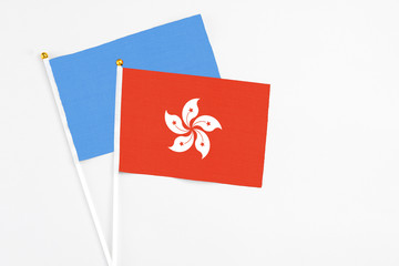 Hong Kong and Somalia stick flags on white background. High quality fabric, miniature national flag. Peaceful global concept.White floor for copy space.