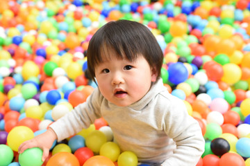 Fototapeta na wymiar Japanese baby / playing in a children's hall ball pool