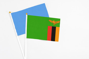 Zambia and Somalia stick flags on white background. High quality fabric, miniature national flag. Peaceful global concept.White floor for copy space.
