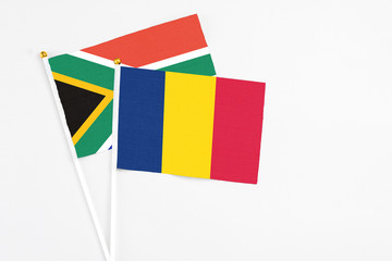 Chad and South Africa stick flags on white background. High quality fabric, miniature national flag. Peaceful global concept.White floor for copy space.