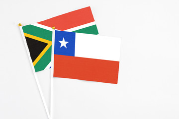 Chile and South Africa stick flags on white background. High quality fabric, miniature national flag. Peaceful global concept.White floor for copy space.