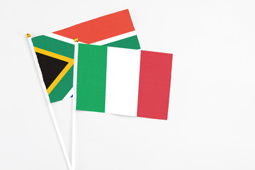 Italy and South Africa stick flags on white background. High quality fabric, miniature national flag. Peaceful global concept.White floor for copy space.