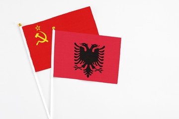Obraz premium Albania and Soviet Union stick flags on white background. High quality fabric, miniature national flag. Peaceful global concept.White floor for copy space.