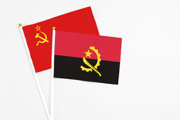 Angola and Soviet Union stick flags on white background. High quality fabric, miniature national flag. Peaceful global concept.White floor for copy space.