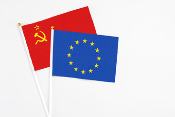 European Union and Soviet Union stick flags on white background. High quality fabric, miniature national flag. Peaceful global concept.White floor for copy space.