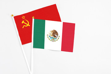 Mexico and Soviet Union stick flags on white background. High quality fabric, miniature national flag. Peaceful global concept.White floor for copy space.