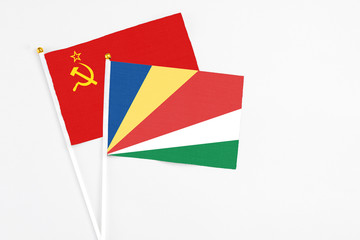 Seychelles and Soviet Union stick flags on white background. High quality fabric, miniature national flag. Peaceful global concept.White floor for copy space.