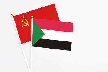 Sudan and Soviet Union stick flags on white background. High quality fabric, miniature national flag. Peaceful global concept.White floor for copy space.