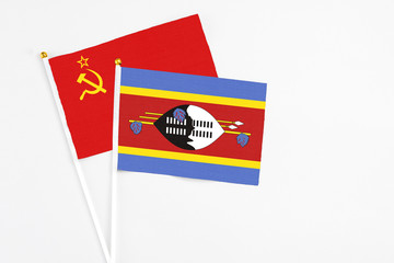 Swaziland and Soviet Union stick flags on white background. High quality fabric, miniature national flag. Peaceful global concept.White floor for copy space.