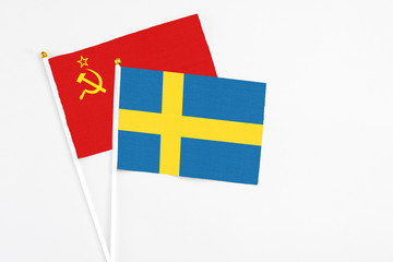 Sweden and Soviet Union stick flags on white background. High quality fabric, miniature national flag. Peaceful global concept.White floor for copy space.