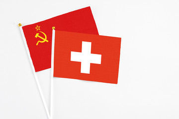 Switzerland and Soviet Union stick flags on white background. High quality fabric, miniature national flag. Peaceful global concept.White floor for copy space.