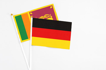 and Sri Lanka stick flags on white background. High quality fabric, miniature national flag. Peaceful global concept.White floor for copy space.