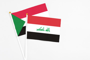 Iraq and Sudan stick flags on white background. High quality fabric, miniature national flag. Peaceful global concept.White floor for copy space.