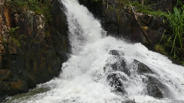 Datanla waterfall in DaLat, Vietnam. Details of a small waterfall. Close view of waterfall and rivier. Waterfall in the forest.