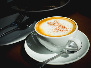 Close up cappuccino hot coffee on wood table in restaurant food and drink backgrounds