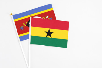 Ghana and Swaziland stick flags on white background. High quality fabric, miniature national flag. Peaceful global concept.White floor for copy space.