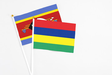 Mauritius and Swaziland stick flags on white background. High quality fabric, miniature national flag. Peaceful global concept.White floor for copy space.
