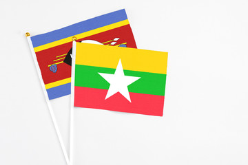 Myanmar and Swaziland stick flags on white background. High quality fabric, miniature national flag. Peaceful global concept.White floor for copy space.