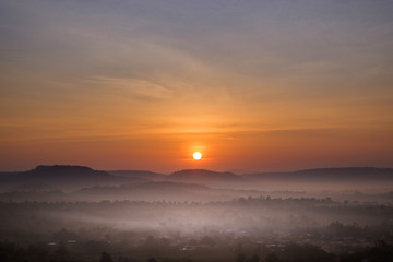 Fototapeta na wymiar Sunlight over the foggy mountain in thailand.