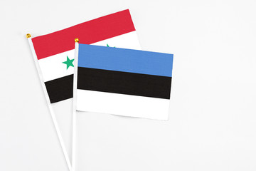Estonia and Syria stick flags on white background. High quality fabric, miniature national flag....