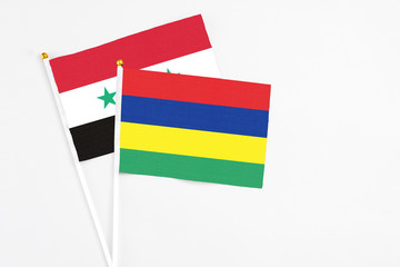 Mauritius and Syria stick flags on white background. High quality fabric, miniature national flag....