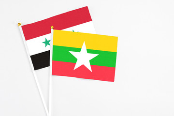 Myanmar and Syria stick flags on white background. High quality fabric, miniature national flag....