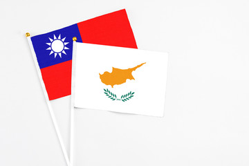 Cyprus and Taiwan stick flags on white background. High quality fabric, miniature national flag. Peaceful global concept.White floor for copy space.