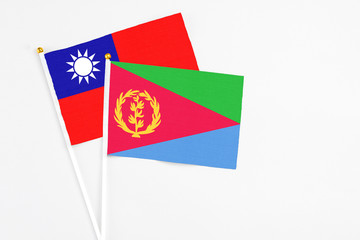 Eritrea and Taiwan stick flags on white background. High quality fabric, miniature national flag. Peaceful global concept.White floor for copy space.