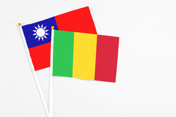 Mali and Taiwan stick flags on white background. High quality fabric, miniature national flag. Peaceful global concept.White floor for copy space.
