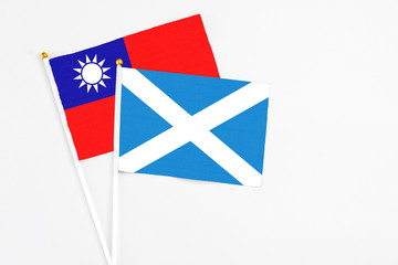 Scotland and Taiwan stick flags on white background. High quality fabric, miniature national flag. Peaceful global concept.White floor for copy space.