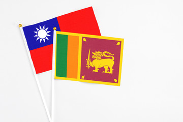 Sri Lanka and Taiwan stick flags on white background. High quality fabric, miniature national flag. Peaceful global concept.White floor for copy space.