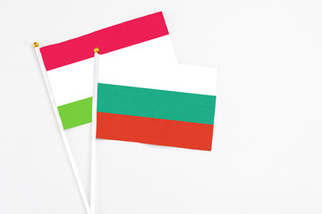 Bulgaria and Tajikistan stick flags on white background. High quality fabric, miniature national flag. Peaceful global concept.White floor for copy space.