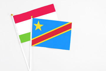 Congo and Tajikistan stick flags on white background. High quality fabric, miniature national flag. Peaceful global concept.White floor for copy space.